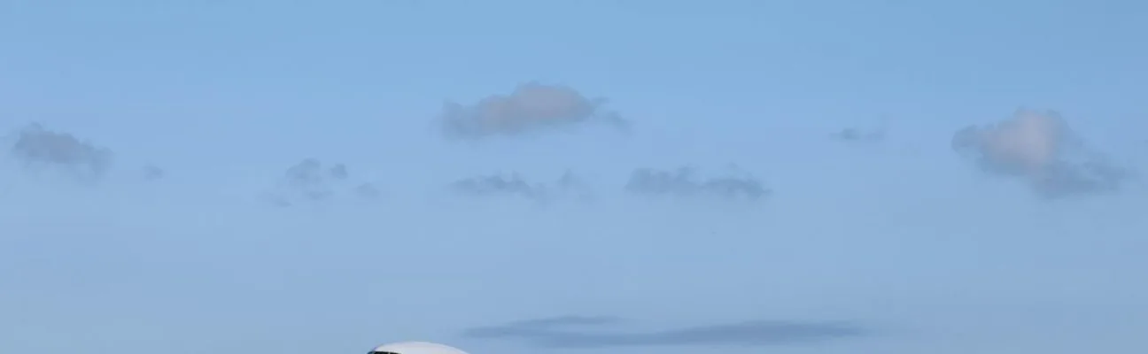 Emirates aircraft takes off against a clear blue sky, perfect for travel themes.